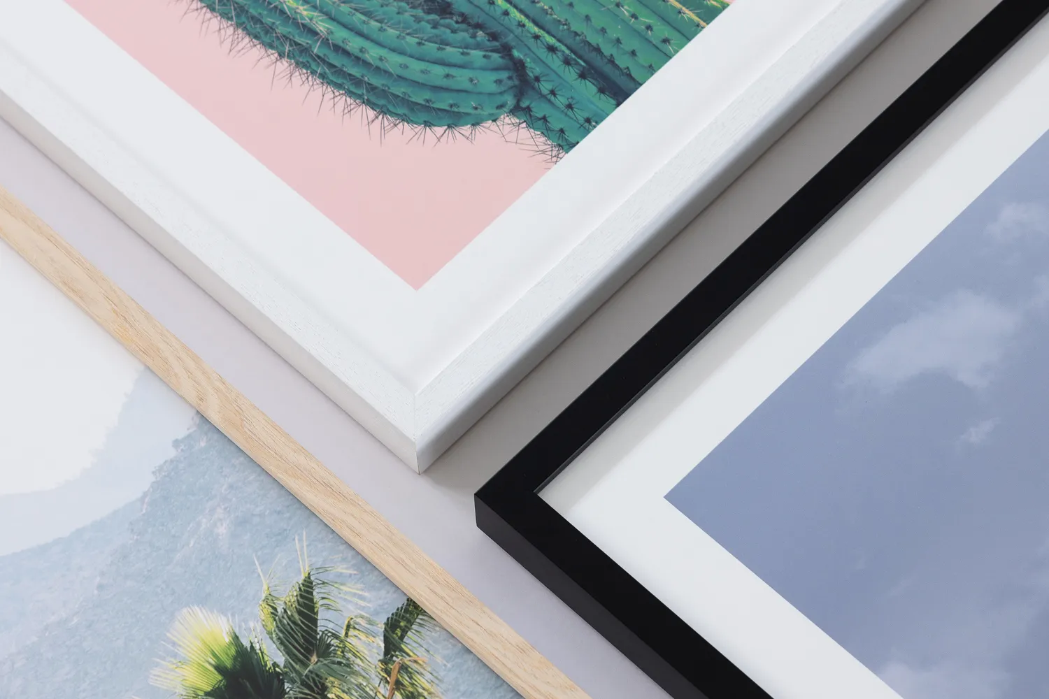 Close up of printed and framed pictures with different frame types including classic black, white timber and oak photo frames supplied by Print Frame Send. 3 different images inside each frame.
